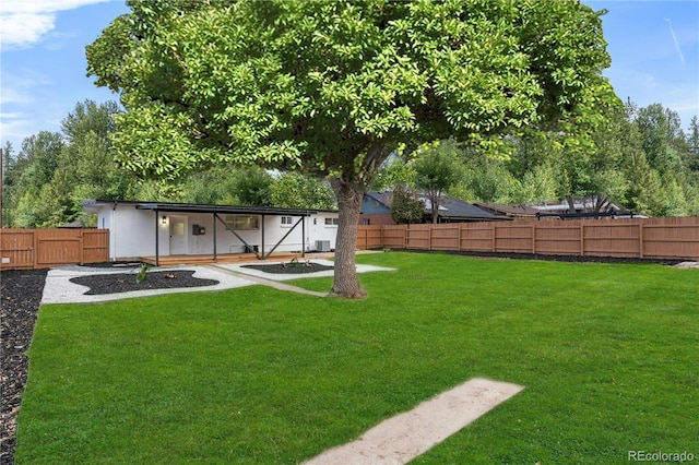 view of yard featuring an outbuilding and a fenced backyard