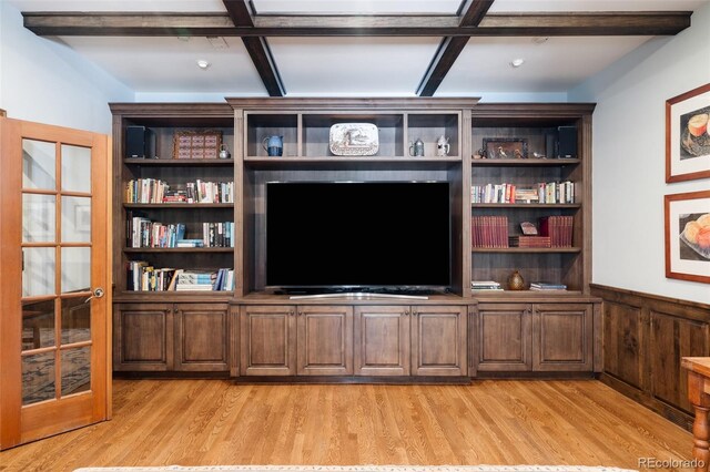 unfurnished living room with light hardwood / wood-style flooring and beamed ceiling