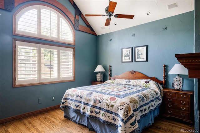 bedroom featuring vaulted ceiling, hardwood / wood-style floors, and ceiling fan