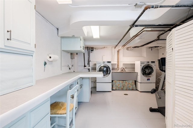 washroom featuring cabinets, sink, and independent washer and dryer