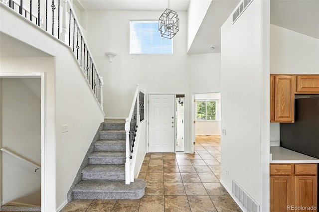 22501 E Belleview Pl, Aurora, CO 80015 - foyer entrance with a high ceiling and stairs