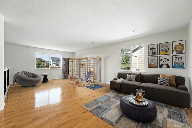 22501 E Belleview Pl, Aurora, CO 80015 - living room featuring plenty of natural light, light wood-style floors, a textured ceiling, and recessed lighting