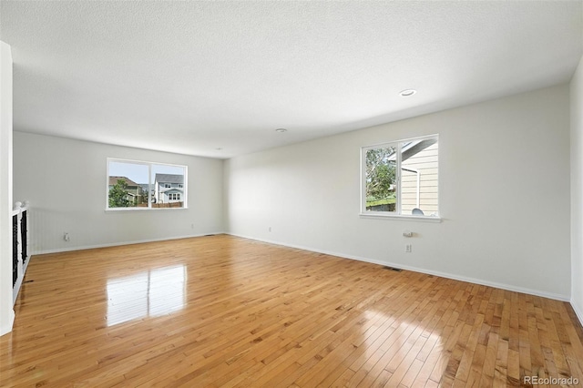 22501 E Belleview Pl, Aurora, CO 80015 - unfurnished living room with light wood-type flooring and baseboards