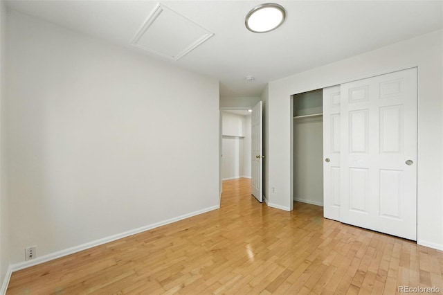 22501 E Belleview Pl, Aurora, CO 80015 - unfurnished bedroom with attic access, light wood-style flooring, and a closet