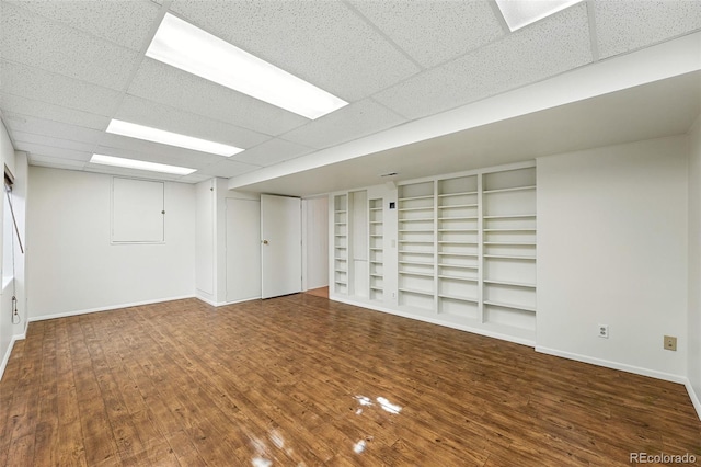 22501 E Belleview Pl, Aurora, CO 80015 - empty room featuring wood finished floors, built in features, and a paneled ceiling
