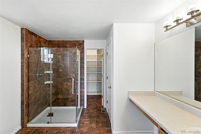22501 E Belleview Pl, Aurora, CO 80015 - full bathroom with a stall shower, vanity, and a spacious closet