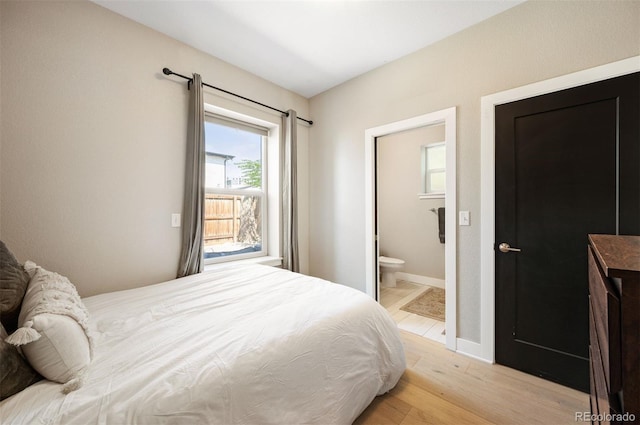 2645 W 24th Ave, Denver, CO 80211 - bedroom with light wood finished floors and ensuite bath