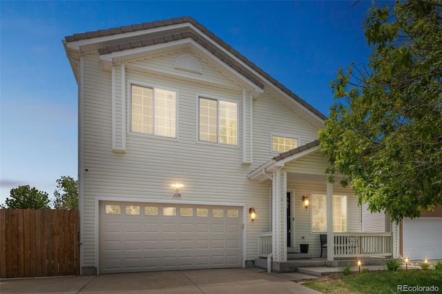 20338 E 48th Dr, Denver, CO 80249 - view of front facade featuring driveway, covered porch, and a garage