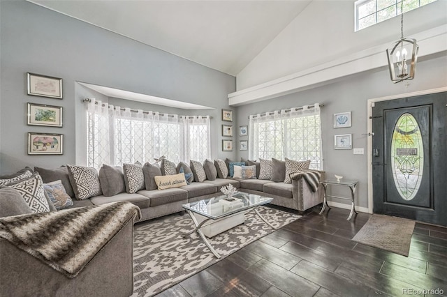 20338 E 48th Dr, Denver, CO 80249 - living room with high vaulted ceiling, healthy amount of natural light, wood finish floors, a chandelier, and baseboards
