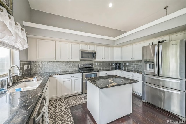 20338 E 48th Dr, Denver, CO 80249 - kitchen featuring stainless steel appliances, a sink, decorative backsplash, dark stone counters, and a center island