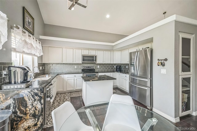 20338 E 48th Dr, Denver, CO 80249 - kitchen with appliances with stainless steel finishes, a sink, a kitchen island, backsplash, and recessed lighting