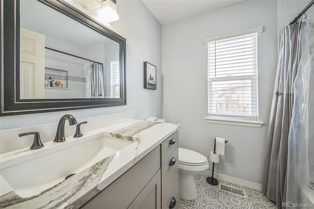 20338 E 48th Dr, Denver, CO 80249 - full bathroom with plenty of natural light, vanity, toilet, and baseboards