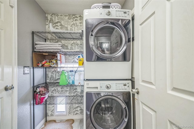 20338 E 48th Dr, Denver, CO 80249 - laundry room with estacked washer and dryer and baseboards