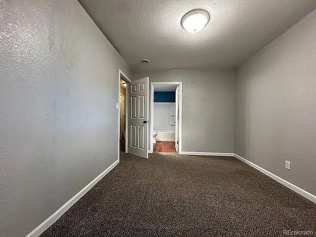921 Dakin St, Denver, CO 80221 - unfurnished room featuring dark colored carpet, a textured ceiling, and a textured wall