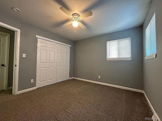 921 Dakin St, Denver, CO 80221 - unfurnished bedroom with dark carpet, a closet, and ceiling fan