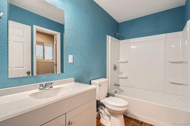 921 Dakin St, Denver, CO 80221 - bathroom with a textured wall, wood finished floors, vanity, and shower / bathtub combination