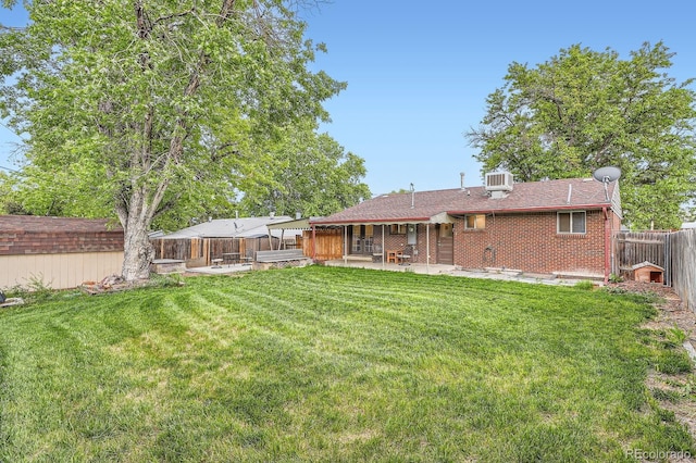 921 Dakin St, Denver, CO 80221 - back of house featuring a patio area, a fenced backyard, and brick siding