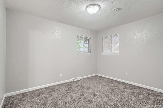 921 Dakin St, Denver, CO 80221 - carpeted empty room with a textured ceiling and baseboards