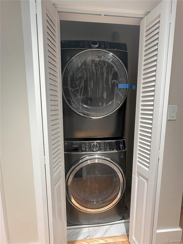 washroom featuring stacked washer and dryer