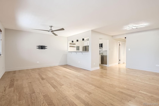 unfurnished living room with ceiling fan and light hardwood / wood-style floors