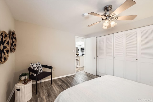 bedroom featuring a closet, dark hardwood / wood-style floors, and ceiling fan