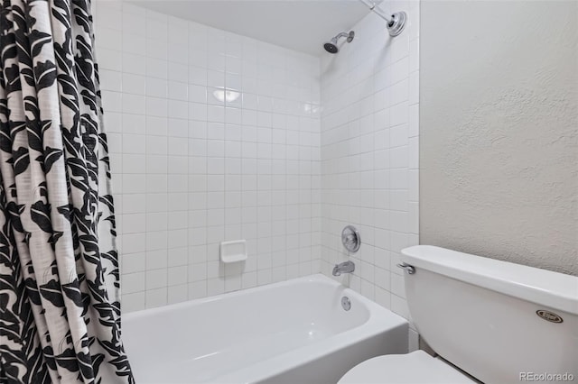 bathroom featuring shower / tub combo with curtain and toilet