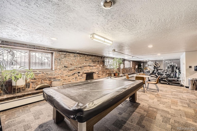 playroom featuring pool table, a baseboard radiator, light colored carpet, and a textured ceiling