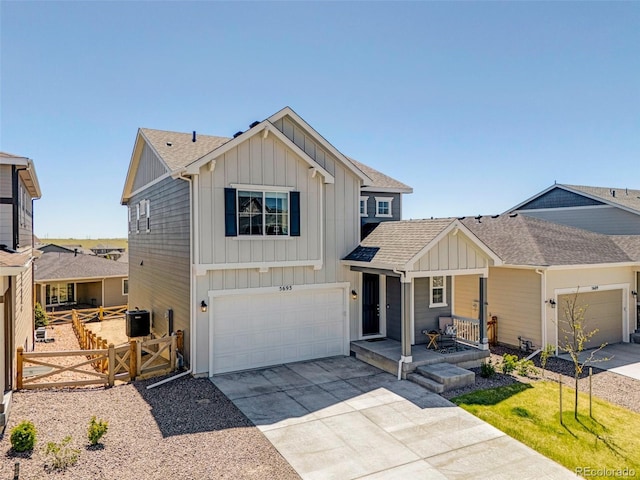 view of front of home featuring board and batten siding, covered porch, driveway, an attached garage, and a shingled roof