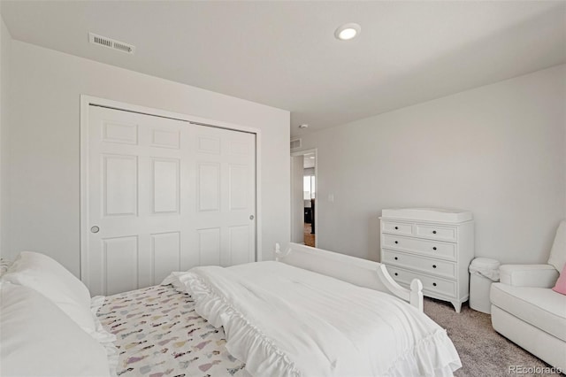 carpeted bedroom with a closet and recessed lighting