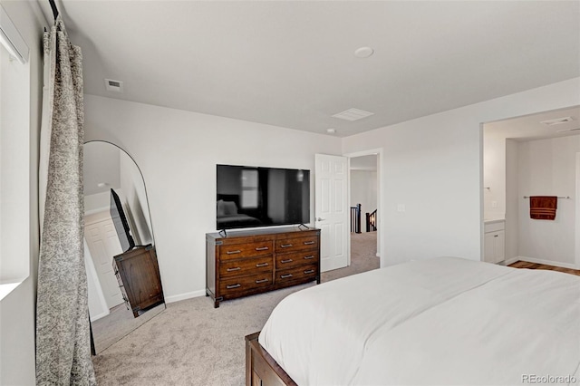 carpeted bedroom with baseboards and ensuite bathroom