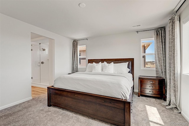 bedroom with light carpet and baseboards