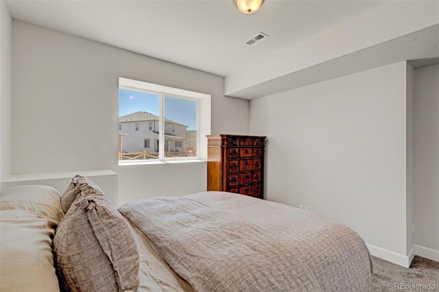 carpeted bedroom with baseboards