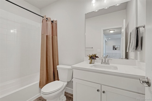 bathroom with toilet, vanity, and shower / bath combo