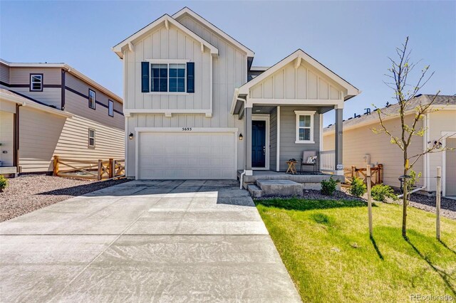 view of front of house with board and batten siding, covered porch, a garage, and driveway