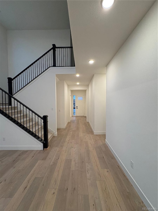 hall with light hardwood / wood-style flooring