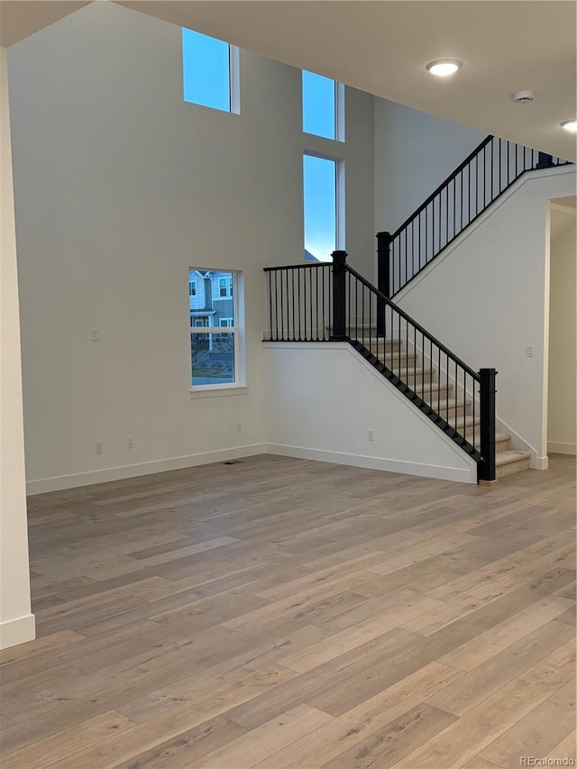 unfurnished living room with a healthy amount of sunlight and light hardwood / wood-style flooring