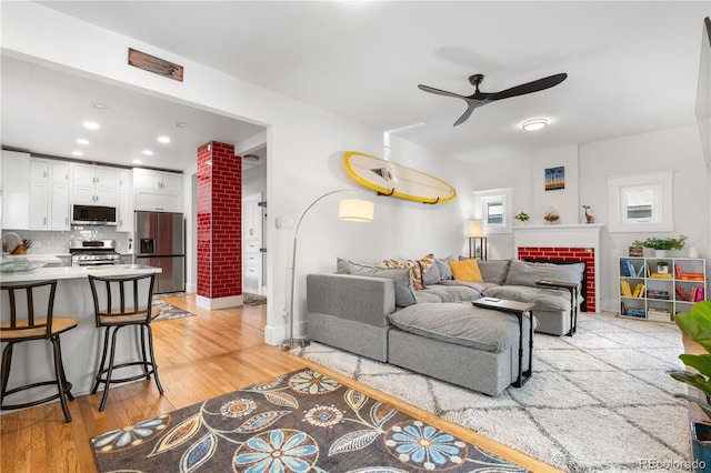 4501 Zenobia St, Denver, CO 80212 - living room featuring ceiling fan, light wood-style flooring, recessed lighting, and decorative columns