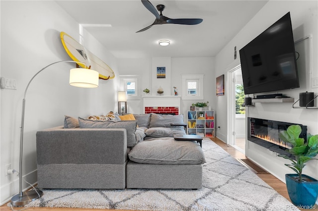 4501 Zenobia St, Denver, CO 80212 - living room featuring a glass covered fireplace, ceiling fan, and wood finished floors