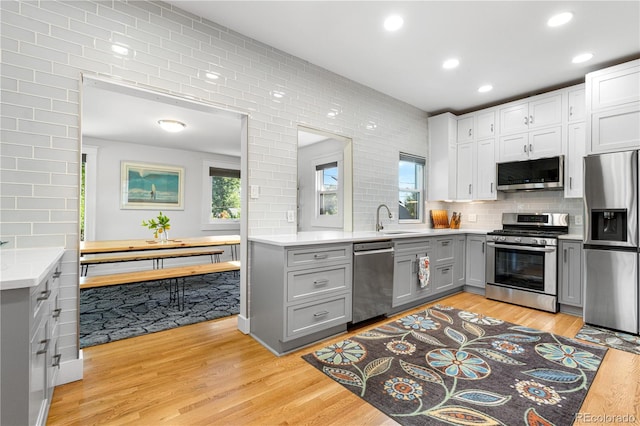 4501 Zenobia St, Denver, CO 80212 - kitchen featuring appliances with stainless steel finishes, gray cabinets, tasteful backsplash, and recessed lighting