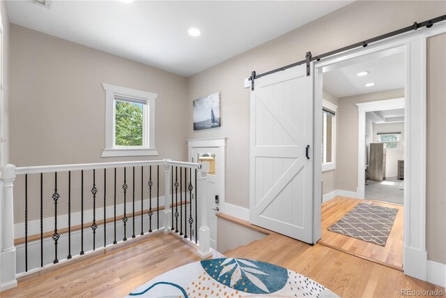 4501 Zenobia St, Denver, CO 80212 - bedroom with a barn door, wood finished floors, and recessed lighting