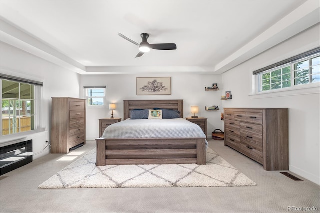 4501 Zenobia St, Denver, CO 80212 - bedroom featuring light carpet, a tray ceiling, and a ceiling fan