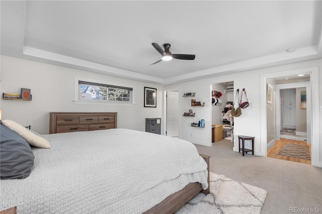 4501 Zenobia St, Denver, CO 80212 - bedroom featuring a raised ceiling, light carpet, a walk in closet, a ceiling fan, and a closet