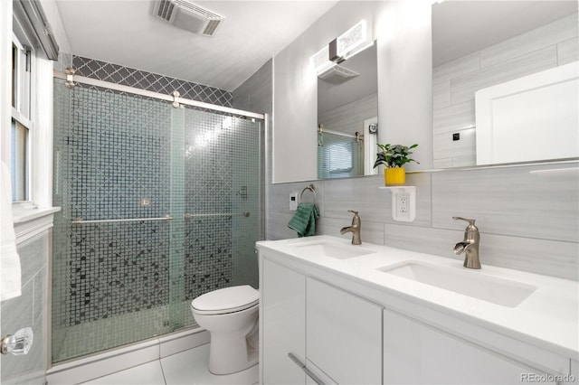 4501 Zenobia St, Denver, CO 80212 - full bath featuring tile walls, double vanity, tile patterned floors, and a stall shower