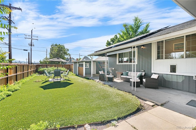4501 Zenobia St, Denver, CO 80212 - fenced backyard featuring an outdoor living space, a patio area, and a storage unit
