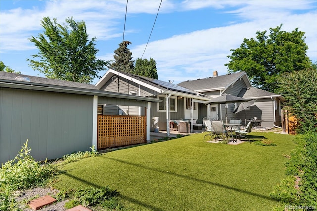 4501 Zenobia St, Denver, CO 80212 - back of property with roof mounted solar panels, a lawn, and a patio area