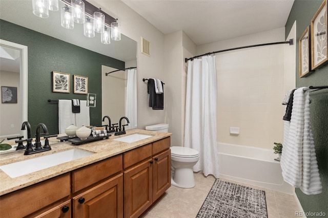full bath featuring toilet, tile patterned floors, shower / bath combination with curtain, double vanity, and a textured wall