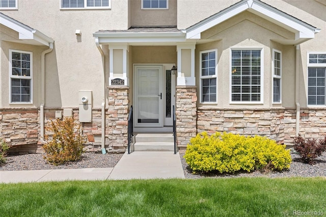 property entrance with stone siding and stucco siding