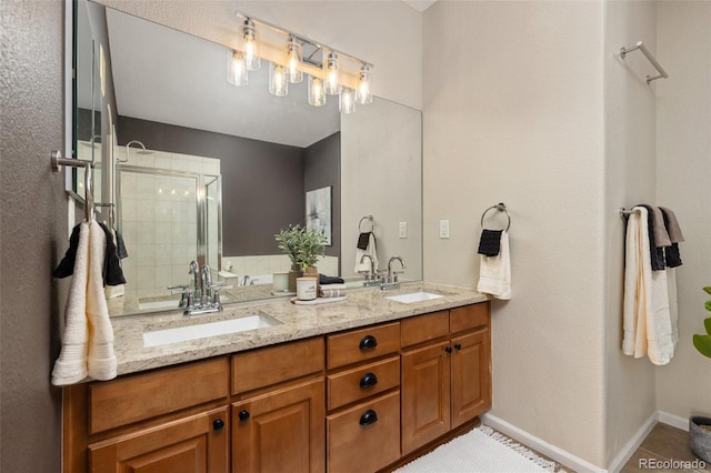 full bathroom featuring a stall shower, double vanity, baseboards, and tile patterned flooring