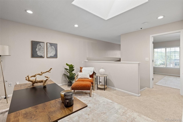 sitting room with carpet floors, a skylight, recessed lighting, and baseboards