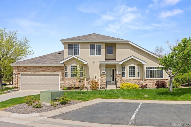 view of front facade with stone siding, stucco siding, a front yard, an attached garage, and roof with shingles